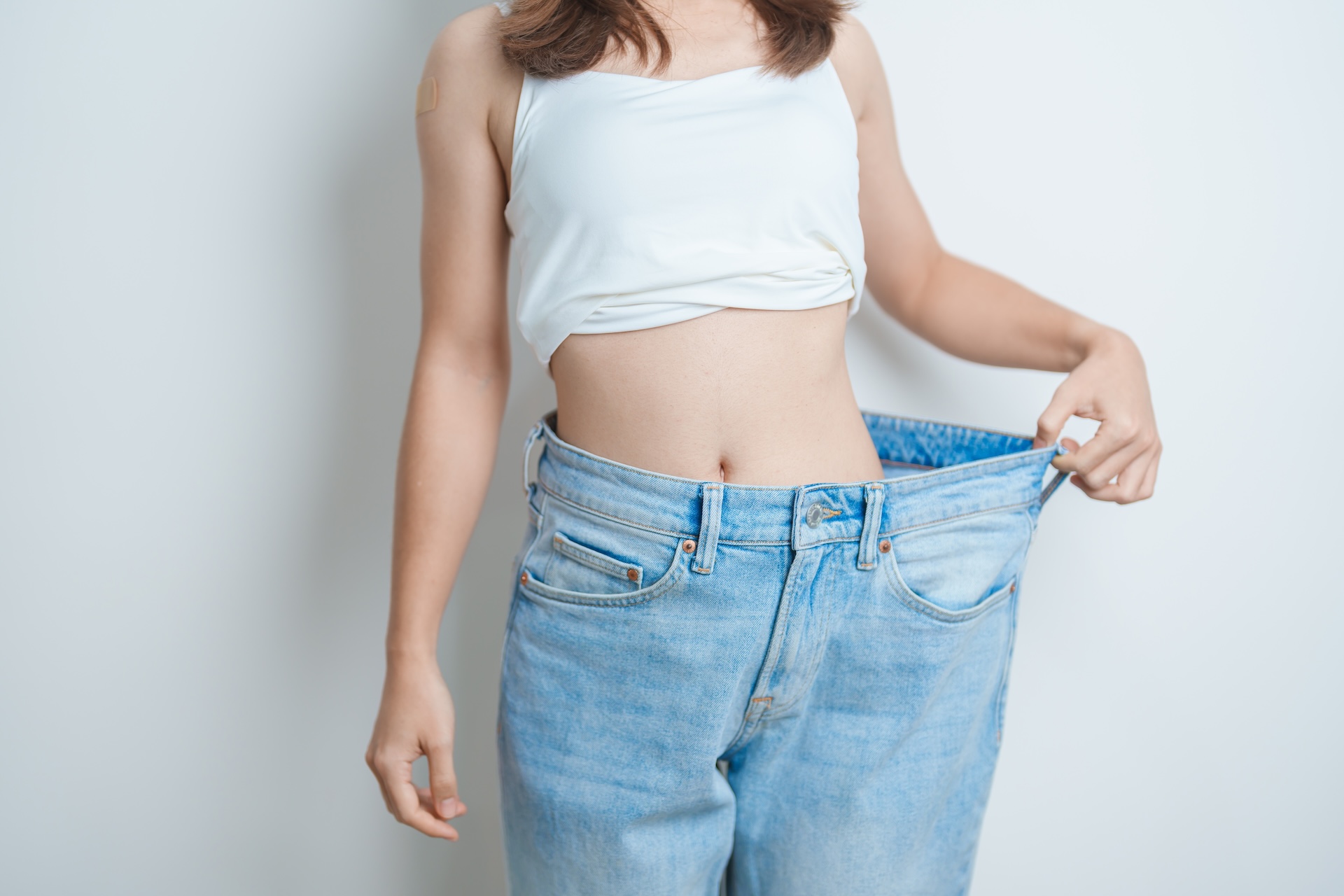 Young,Slim,Female,Wearing,Big,Or,Oversize,Jeans,,Woman,Show GLP-1
